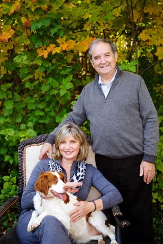 A couple getting a Fall portrait with their pet dog at cottage in Meaford, Ontario.