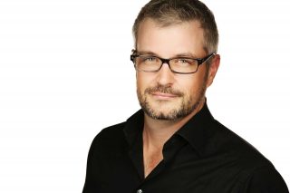 Professional headshot of a man with glasses in Guelph.